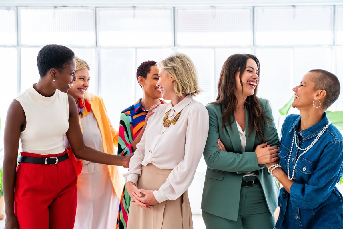 Group of beautiful confident businesswomen meeting in the office - Multiethinc female creative team brainstorming at work - Diverse colleagues working together in workshop in a co-working space